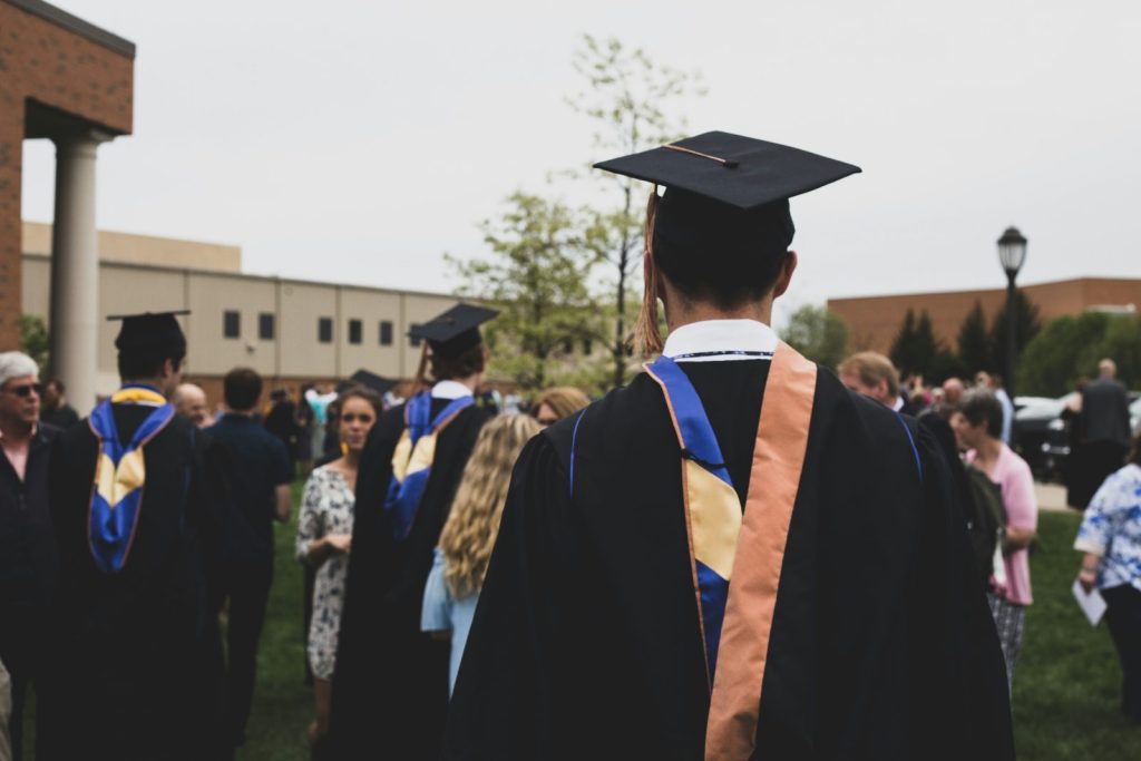 Graduate wearing academic gown after completing an MBA program